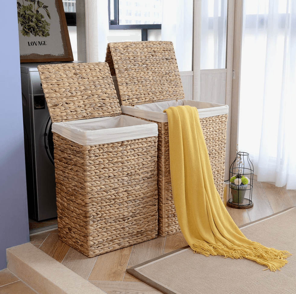 Two open wicker baskets with a yellow blanket draped over one.
