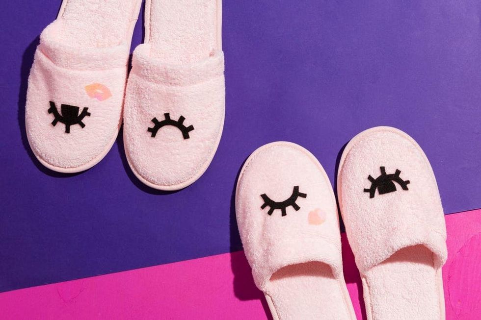 two pairs of slippers on a pink and purple background