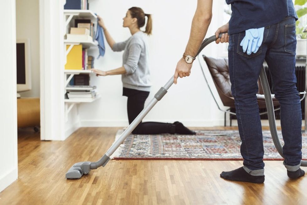 Two people clean in a home