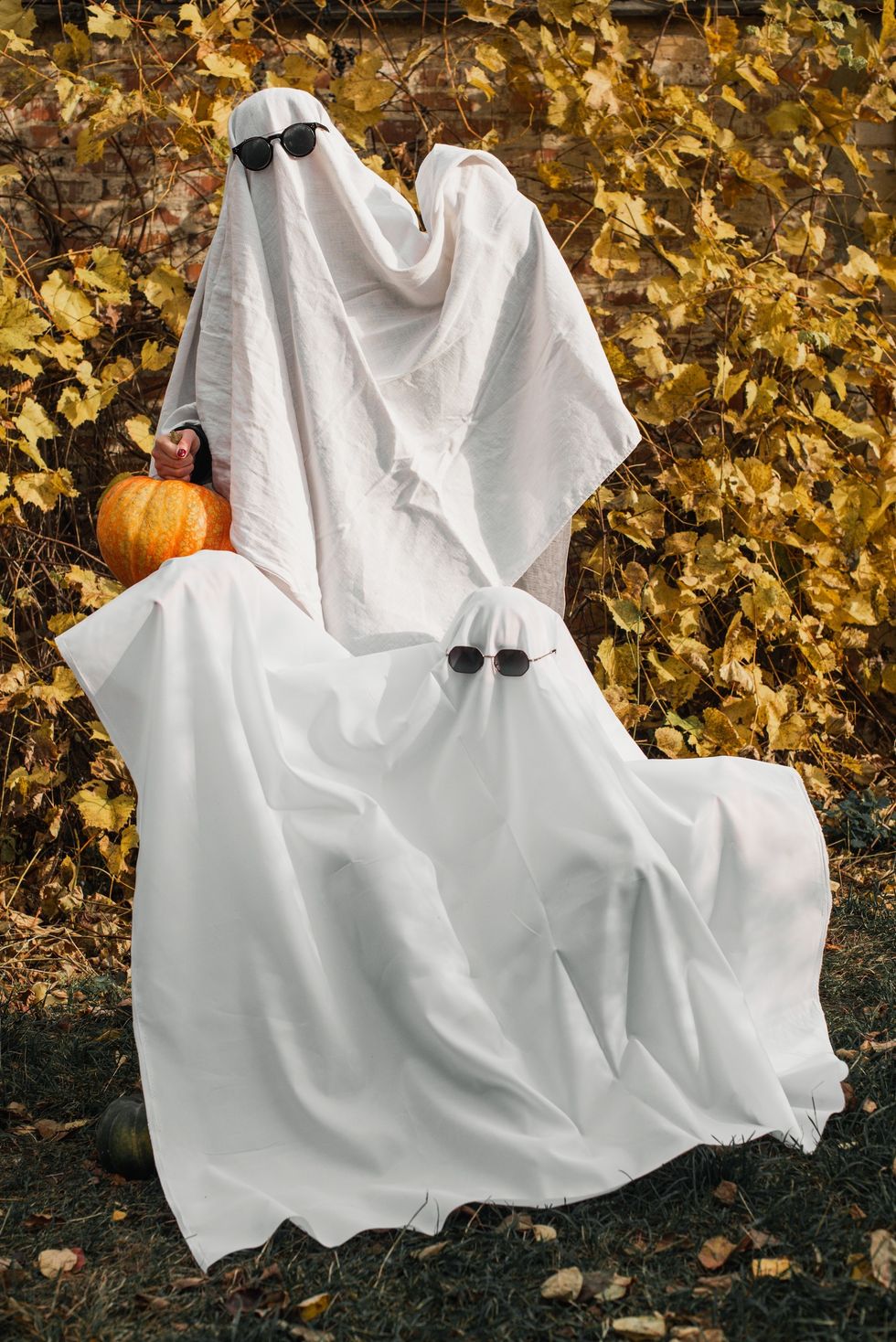 two people dressed up as ghosts for halloween
