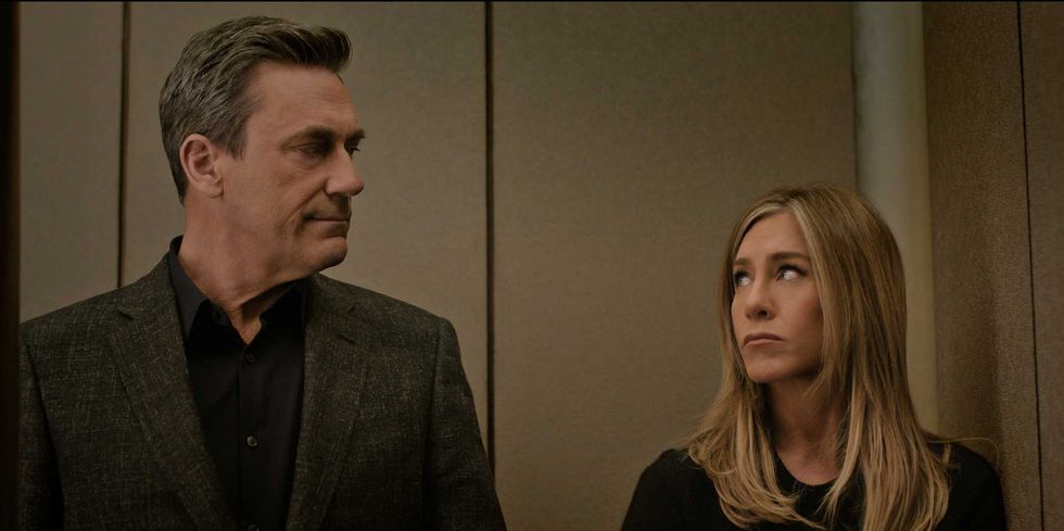 Two people standing next to each other, sharing an inquisitive glance.