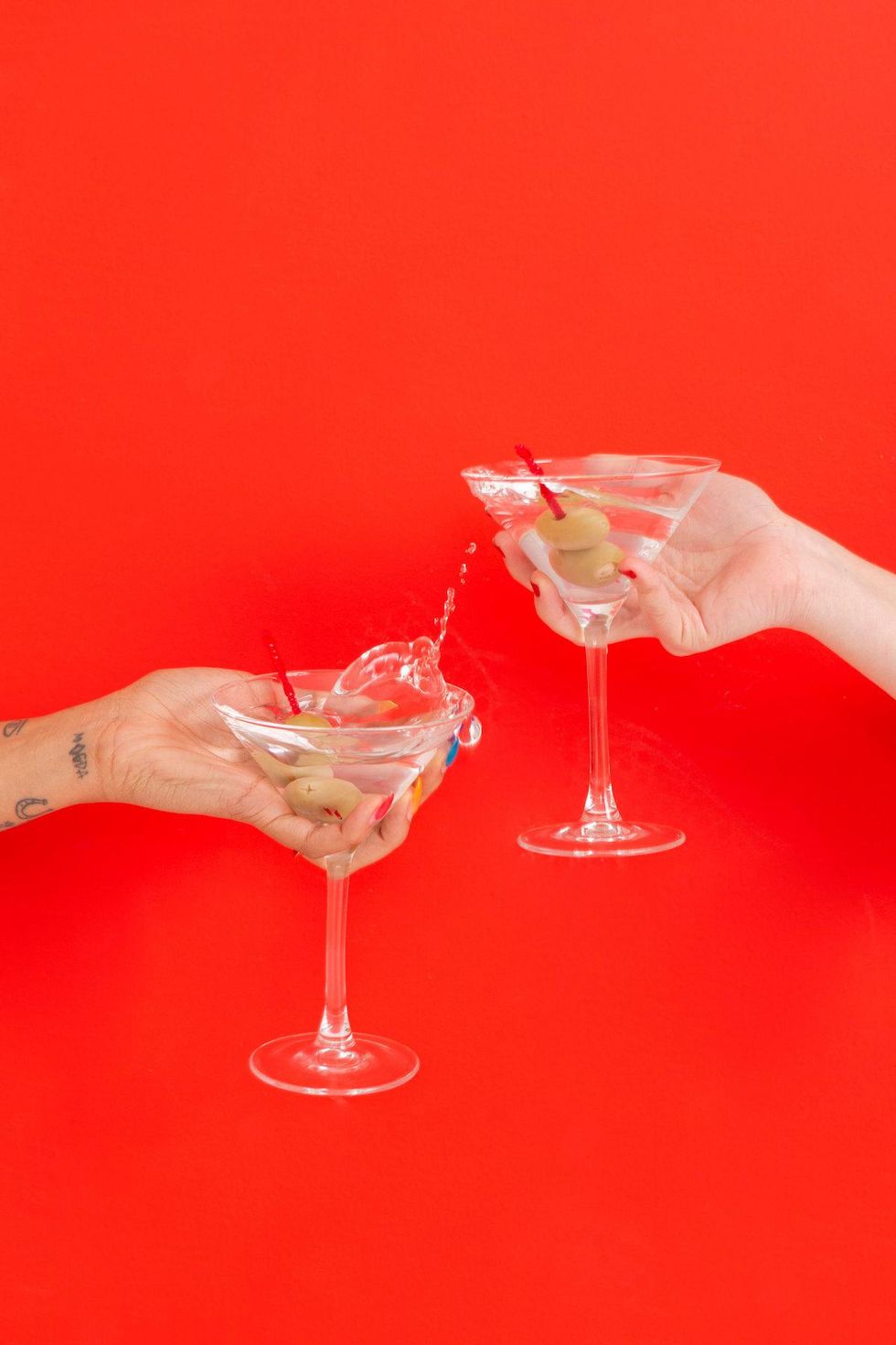 two women clinking their martinis together