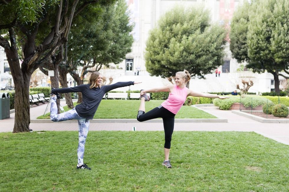 two women doing yoga togther
