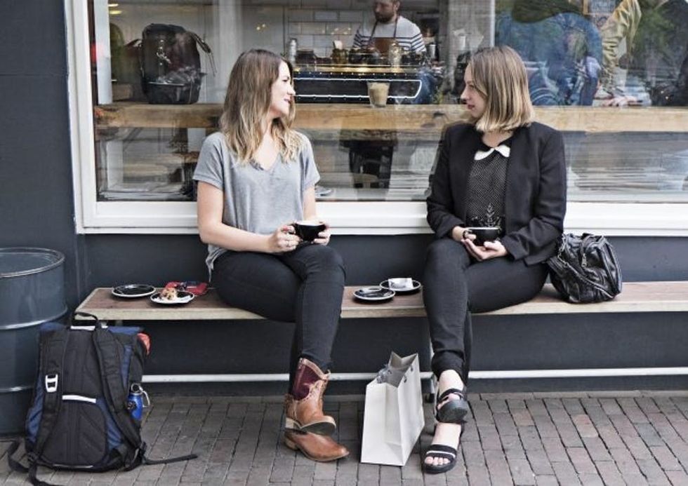 Two women drinking coffee together