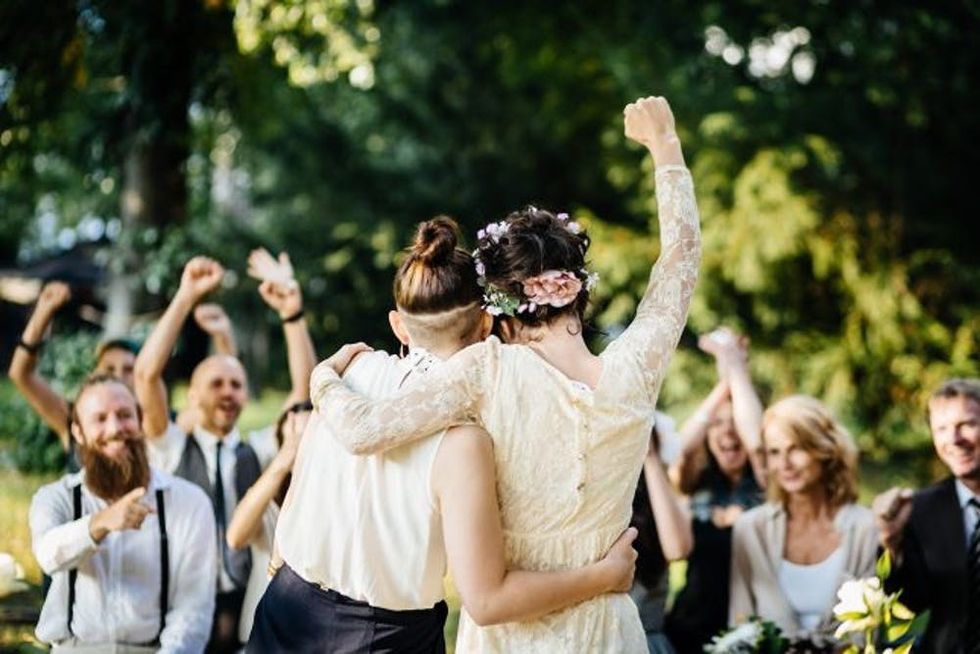 Two women embrace as they celebrate their marriage
