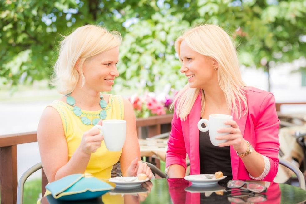 Two women have coffee together in Estonia