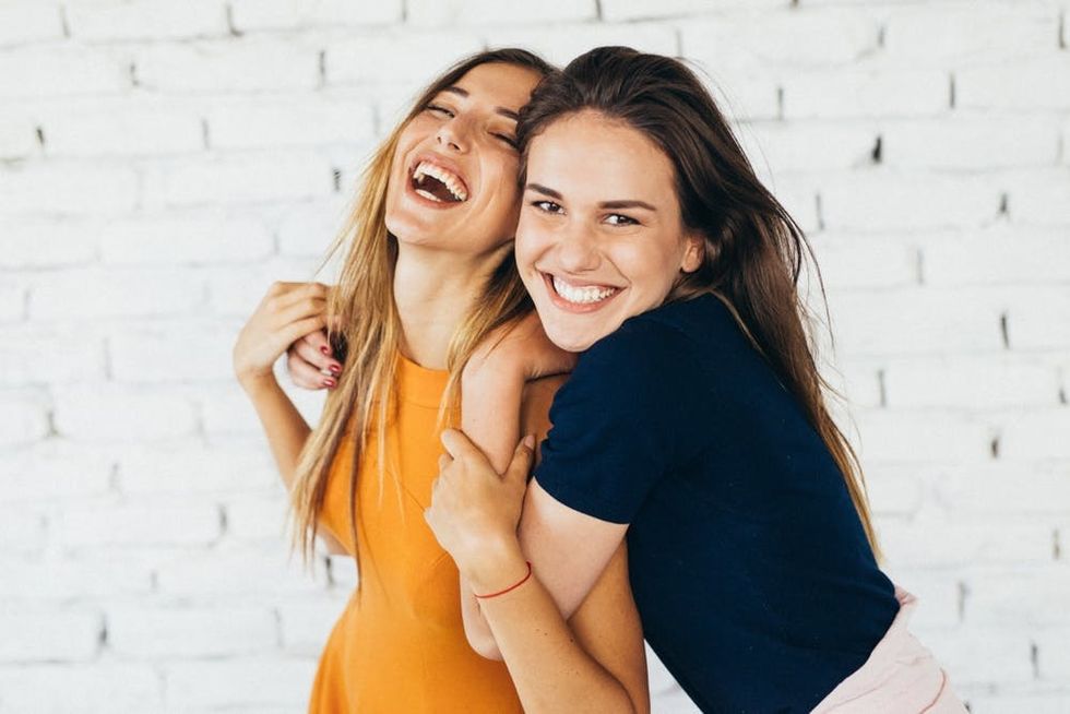 Two women hug while laughing