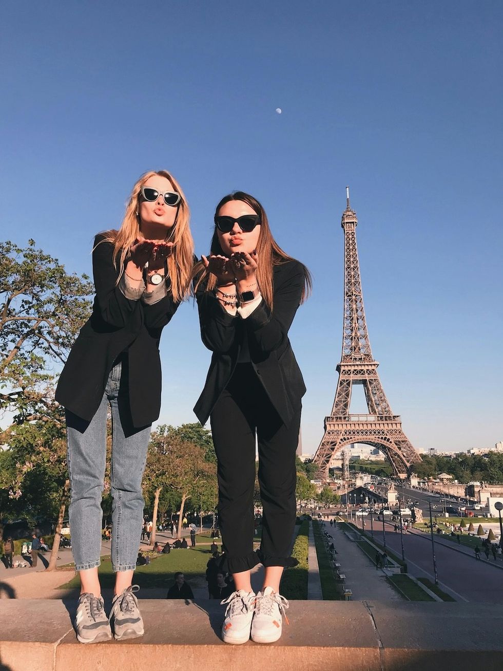 two women in front of the eiffel tower in paris