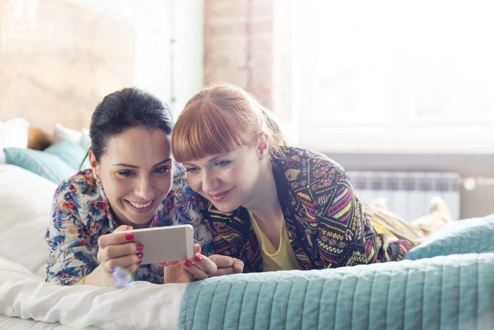 Two women look at a phone together