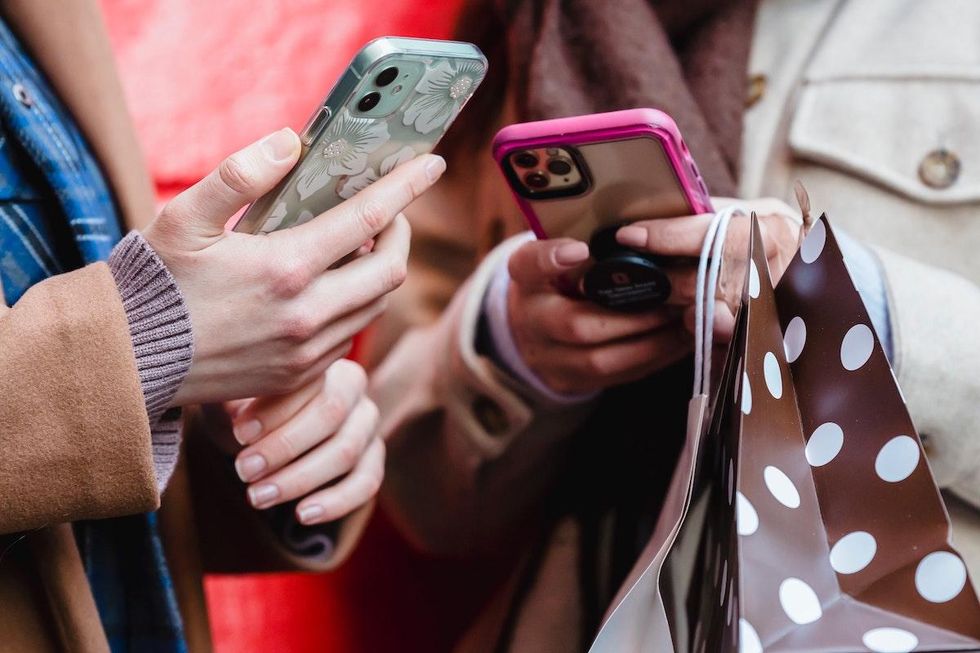 two women looking at their phones
