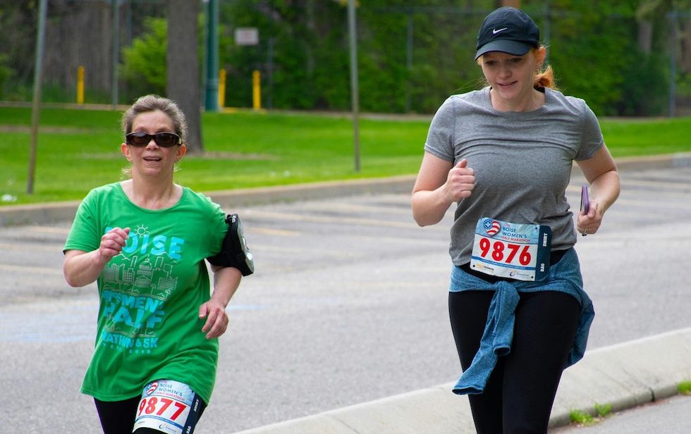 two women running in a st patrick's day race