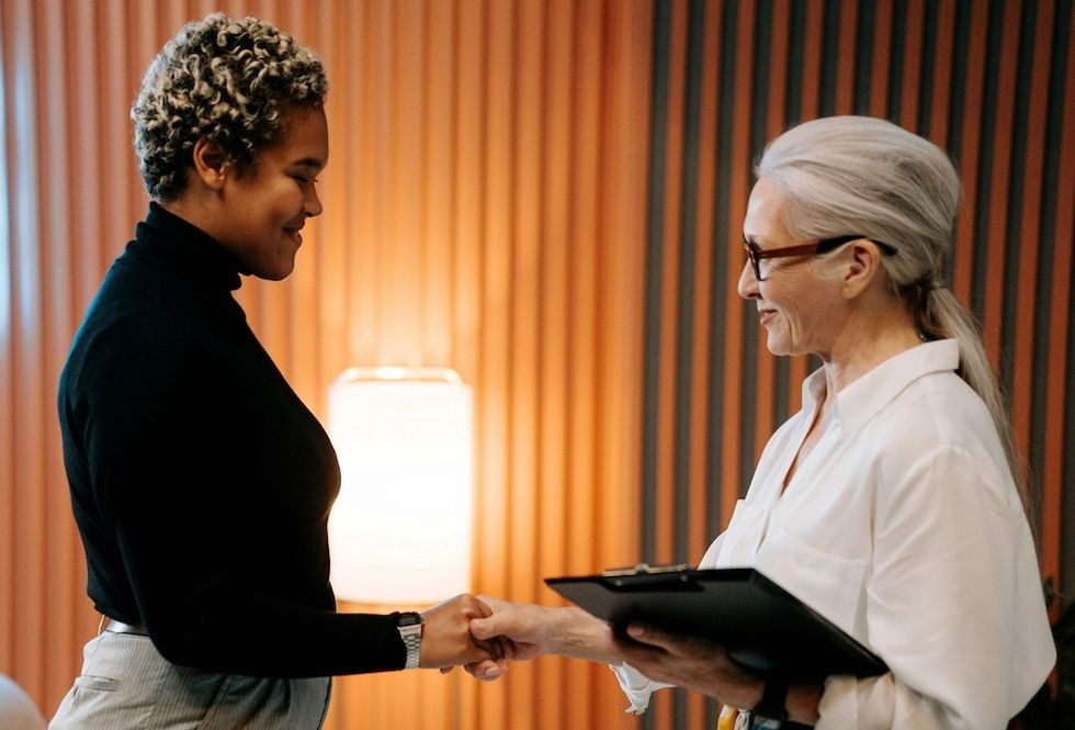 two women shaking hands
