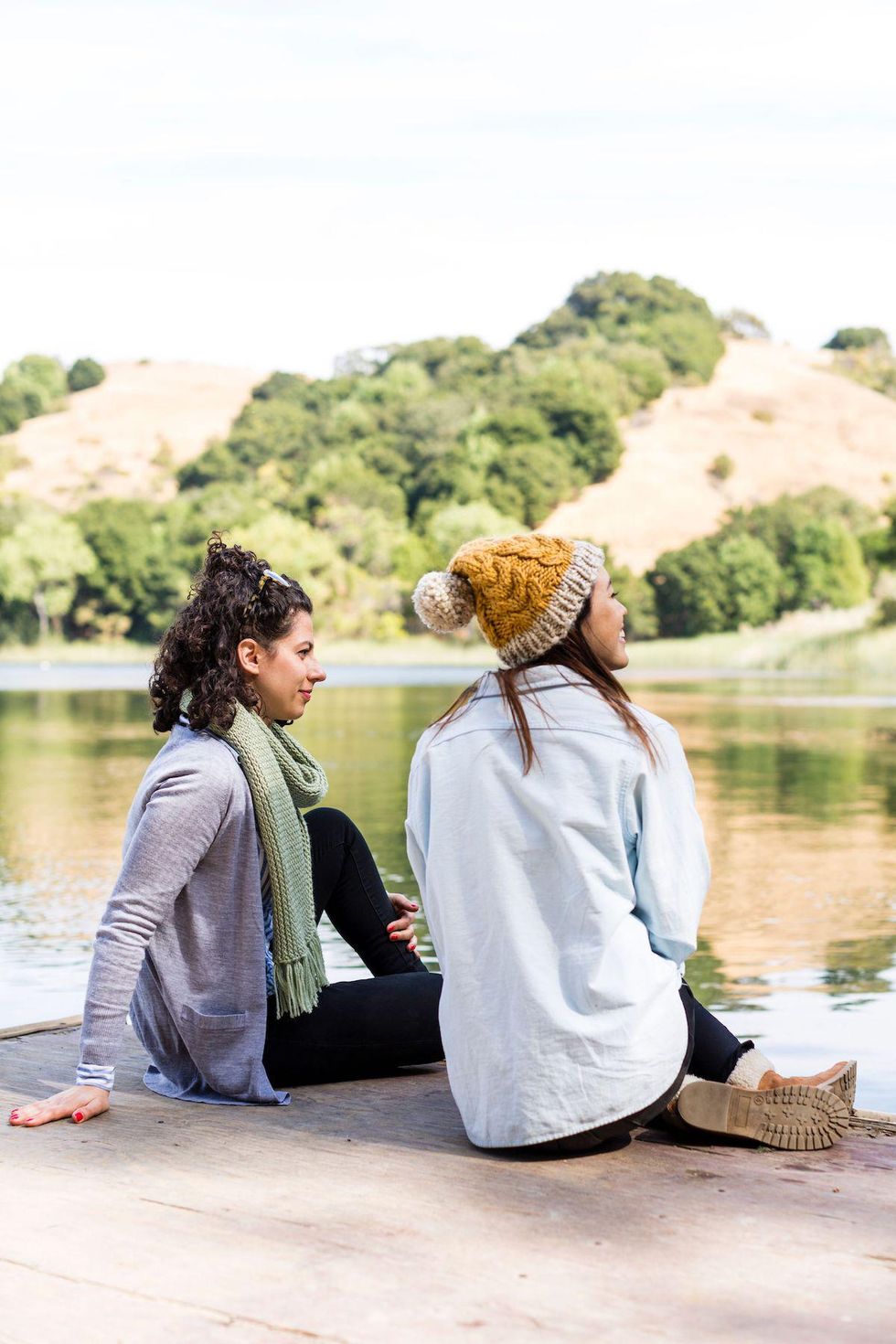 two women sitting outside in nature