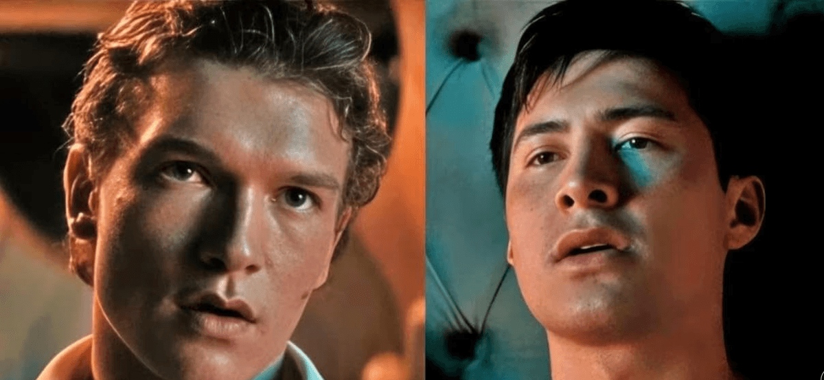 Two young men looking intently, teal and warm lighting highlighting their features.