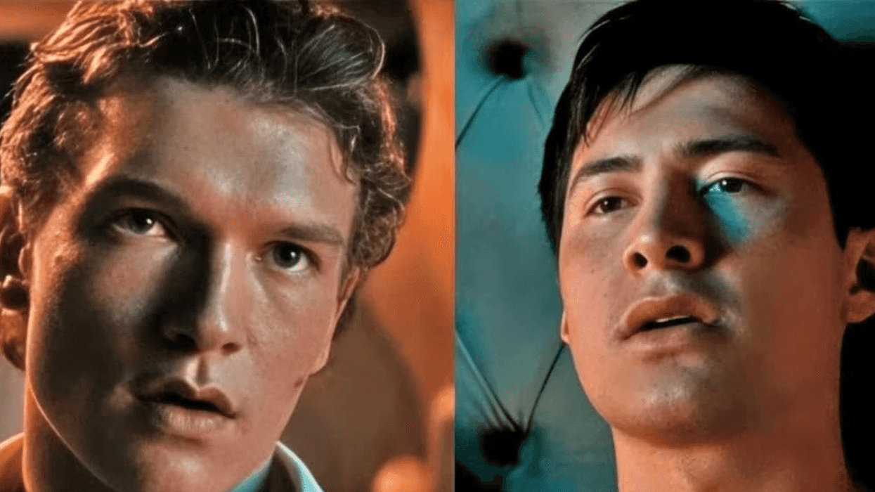 Two young men looking intently, teal and warm lighting highlighting their features.
