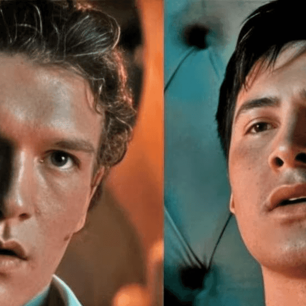 Two young men looking intently, teal and warm lighting highlighting their features.