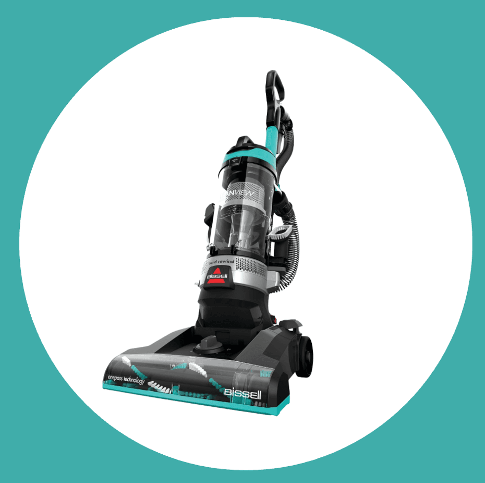 Upright Bissell vacuum cleaner on a turquoise background.