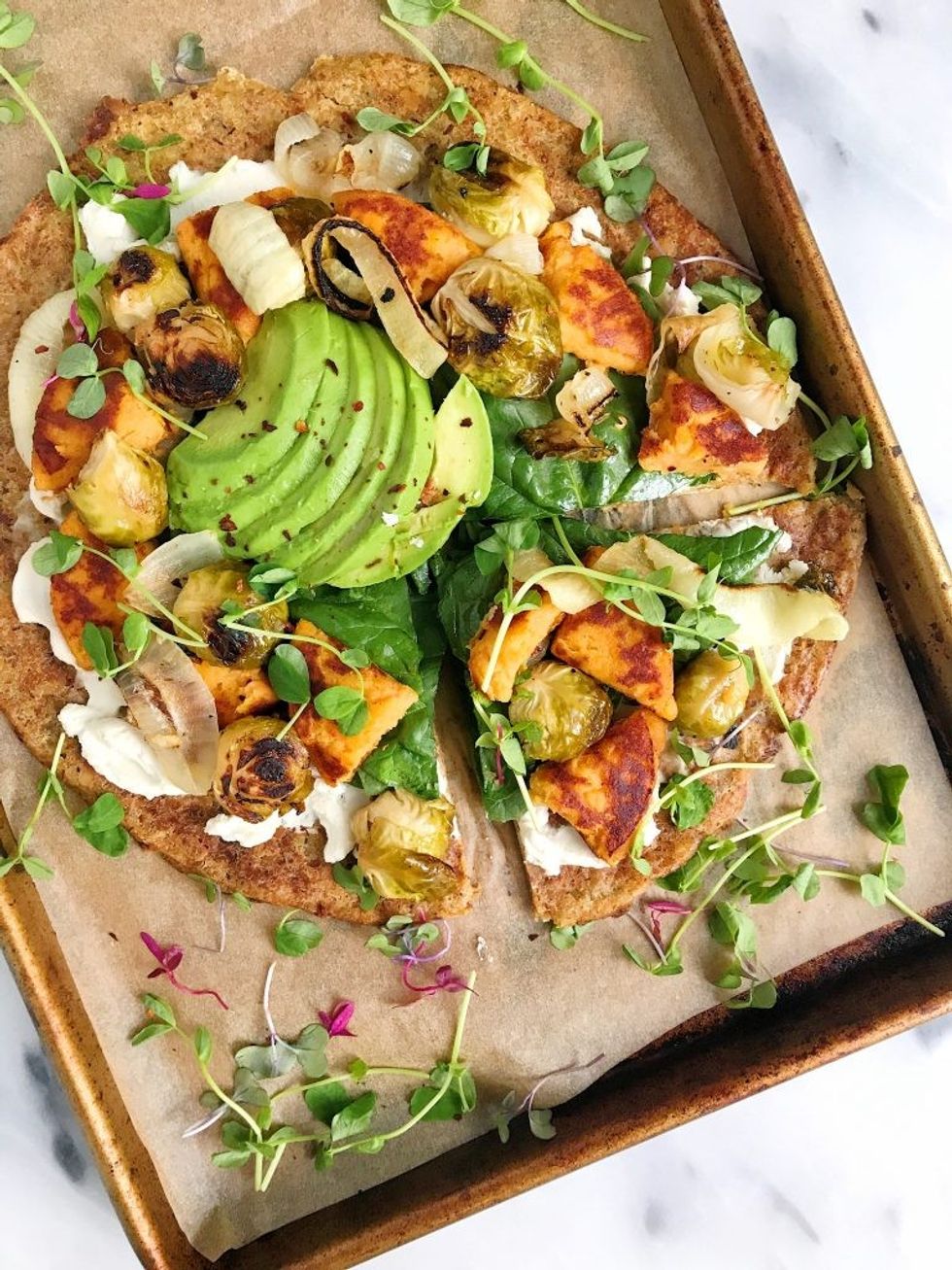 Vegan breakfast pizza sits on a pan.