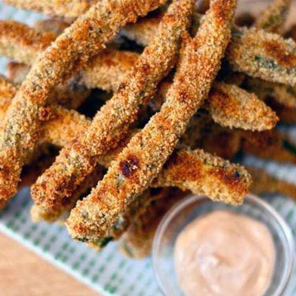 veggie fries on a blue and white gingham tray beside a sriracha sauce