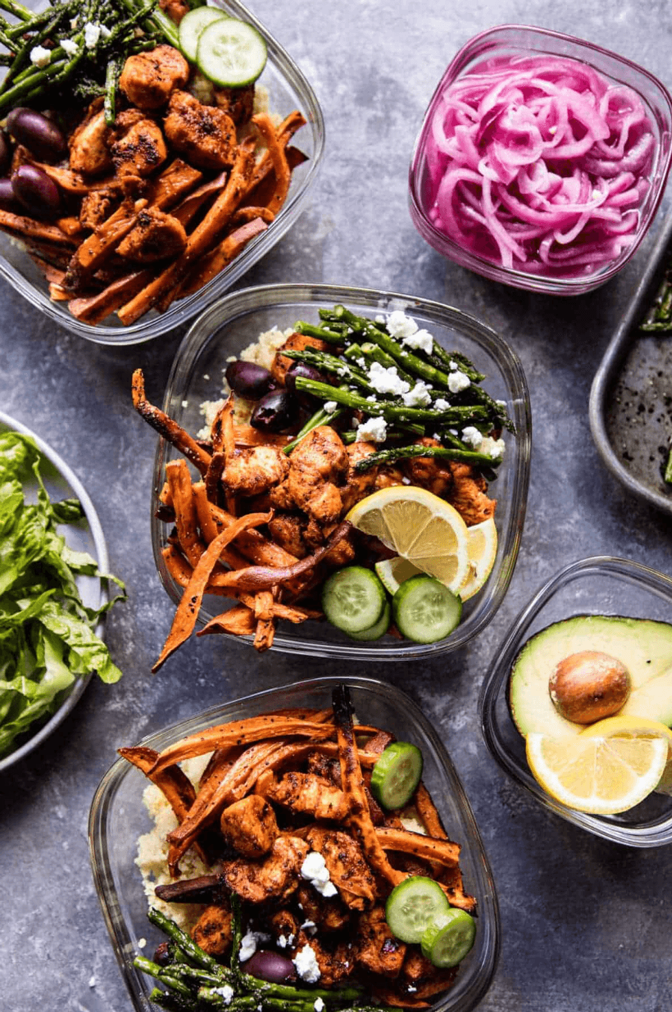 Vibrant meal prep bowls with chicken, sweet potato, cucumber, asparagus, and lemon.