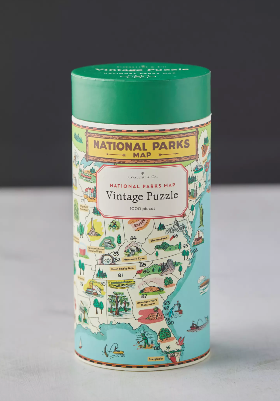 Vintage National Parks map puzzle tube with green lid, featuring park illustrations.