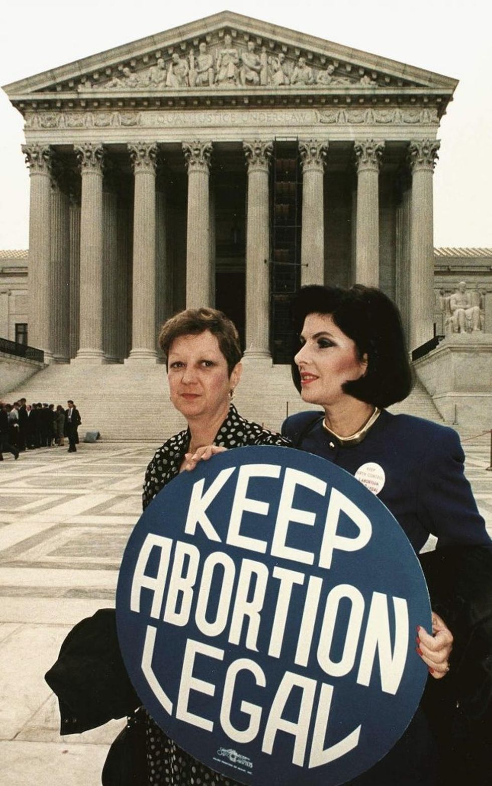 WASHINGTON, DC - APRIL 26: This file photo shows Norma McCorvey(L) formally known as "Jane Roe",as she holds a pro-choice sign with former attorney Gloria Allred(R) in front of the US Supreme Court building 26 April 1989,in Washington,DC, just before attorneys began arguing the 1973 landmark abortion decision which legalized abortion in the US. (Photo credit should read GREG GIBSON/AFP/Getty Images)