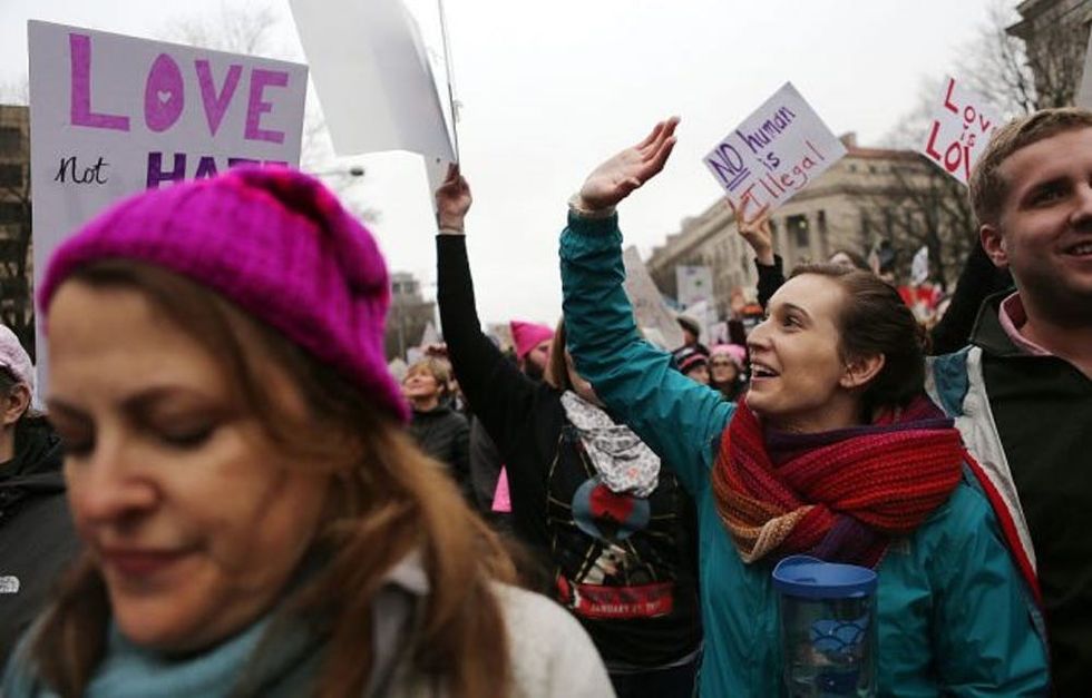 WASHINGTON, DC - JANUARY 21: Protesters march during the Women's March on Washington on January 21, 2017 in Washington, DC. Large crowds are attending the anti-Trump rally a day after U.S. President Donald Trump was sworn in as the 45th U.S. president. (Photo by Mario Tama/Getty Images)