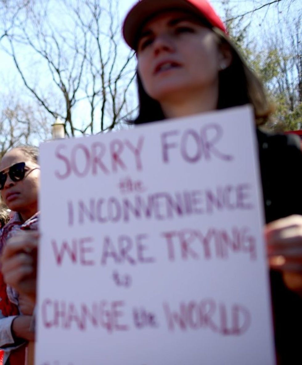 WASHINGTON, DC - MARCH 08: Protesters hold signs during a march and rally to support women's health programs and protest the White House global gag rule on March 8, 2017 in Washington, DC. Hundreds of women marked International Women's Day with a march and rally outside of the White House to protest the White House global gag rule and support women's health programs. (Photo by Justin Sullivan/Getty Images)