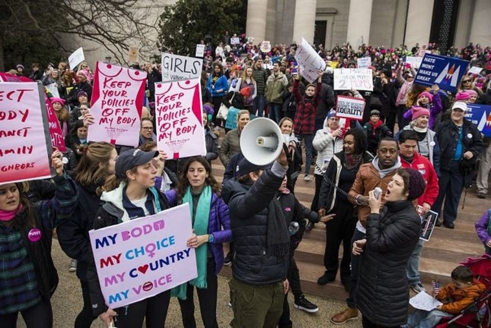 WASHINGTON, USA - JANUARY 21: Protesters attend the Women's March to protest President Donald Trump in Washington, USA on January 21, 2017. (Photo by Samuel Corum/Anadolu Agency/Getty Images)