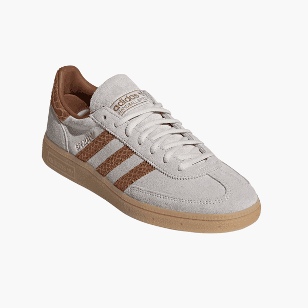 White Adidas suede sneaker with brown textured stripes and gum sole, shown on a white background.