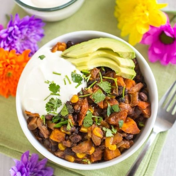 White bowl with sweet potatoes, corn, and beans make for a great make ahead camping meal.