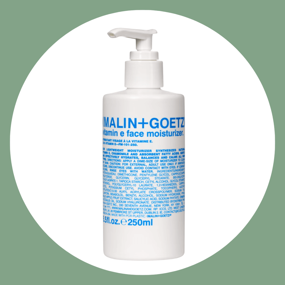 White pump bottle of Malin+Goetz Vitamin E Face Moisturizer on green background.