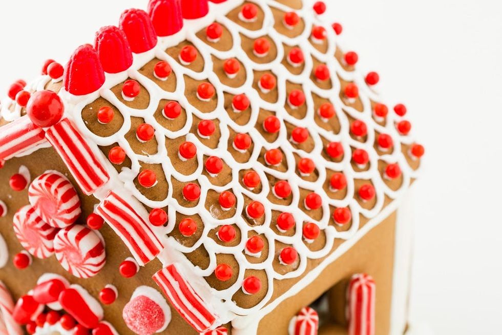 white scalloped roof on house with red ball candy