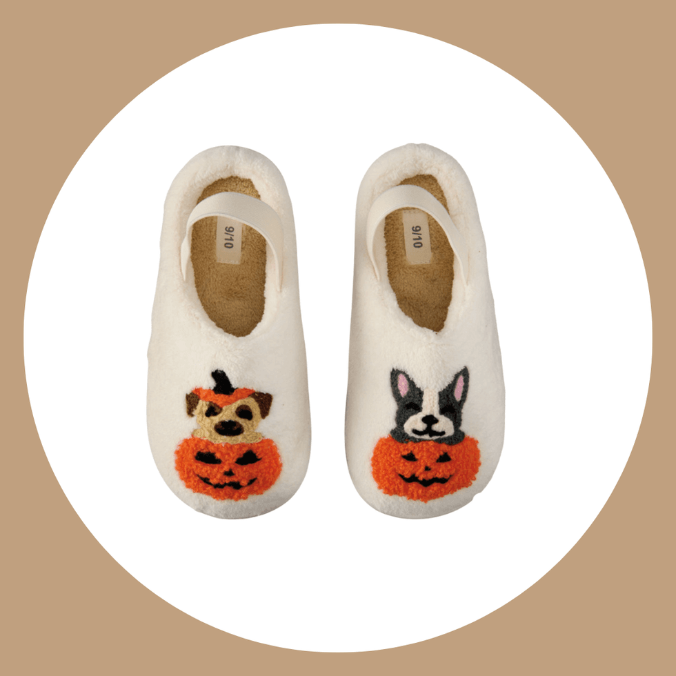 White slippers with Halloween dog and bunny pumpkin designs on a tan background.