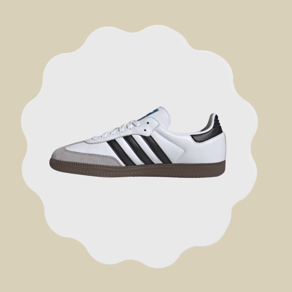 White sneaker with black stripes and brown sole on a scalloped background.