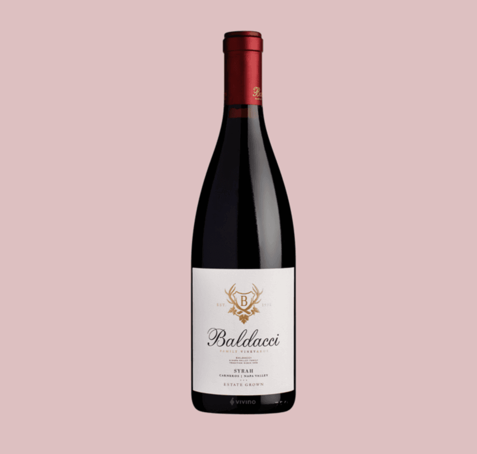Wine bottle with "Baldacci Family Vineyards" label on a pink background.