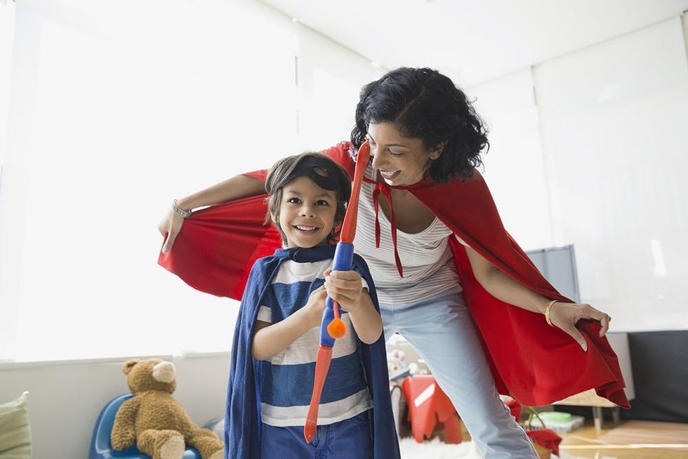 Woman and boy in superhero capes