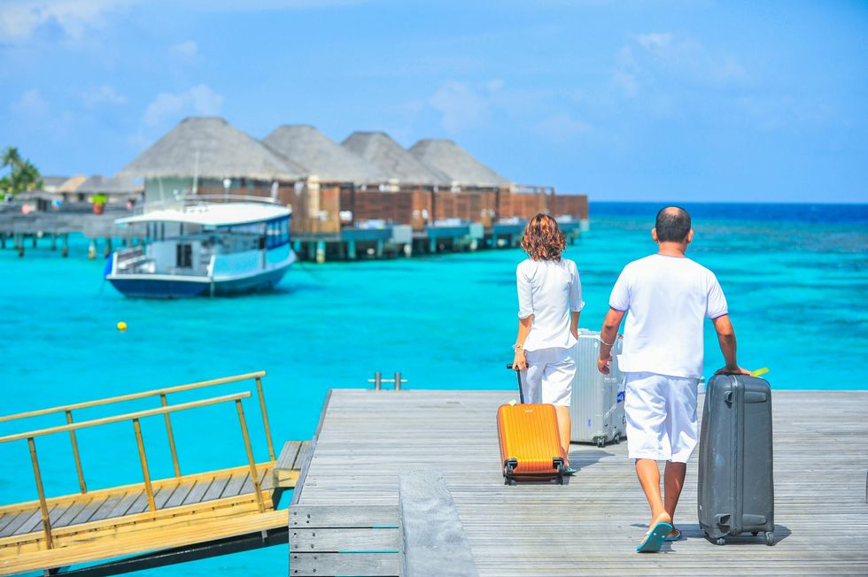 woman and man arriving at maldives birthday trip ideas