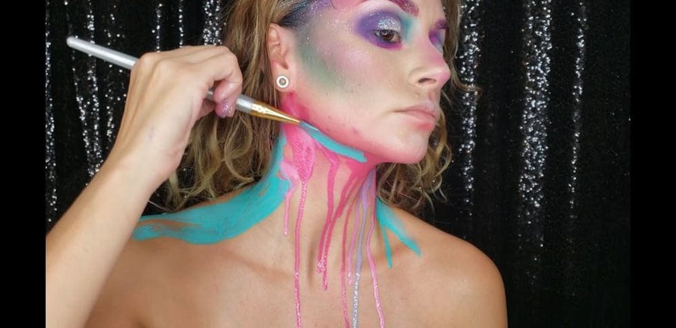 Woman applying drip makeup to neck. 
