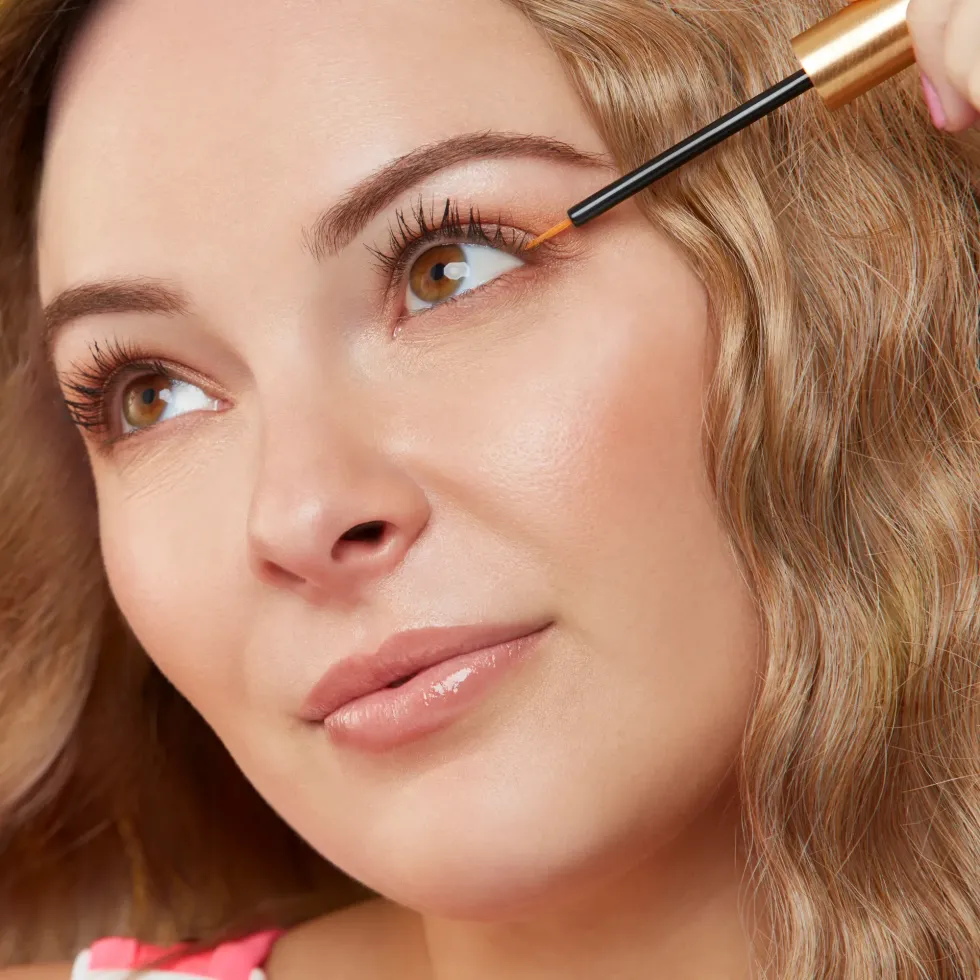 woman applying GrandLash-MD lash growth serum