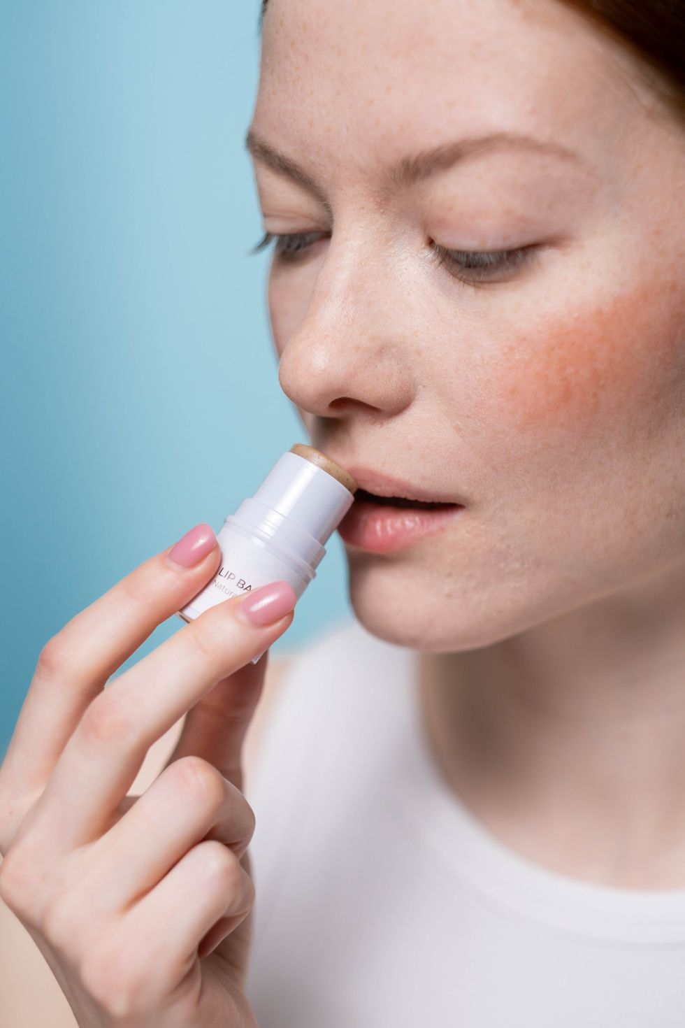 woman applying lip balm