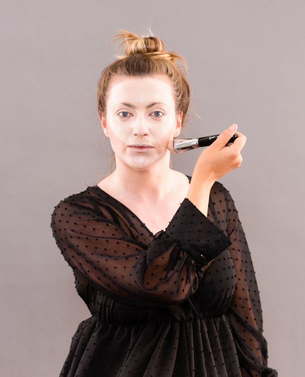 Woman applying makeup.