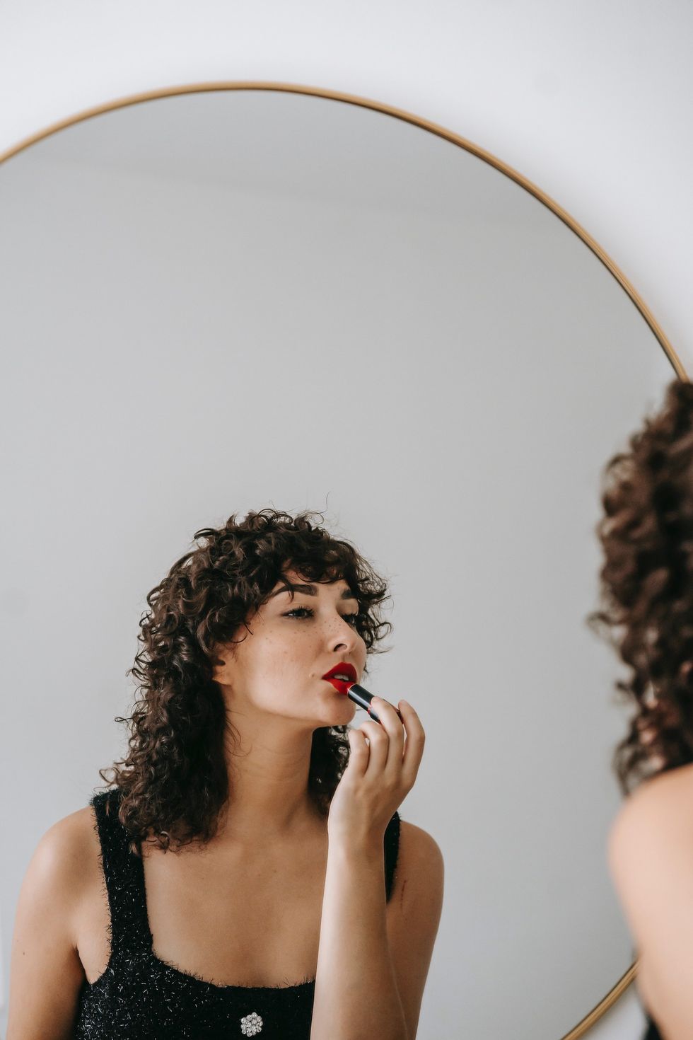 Woman applying red lipstick