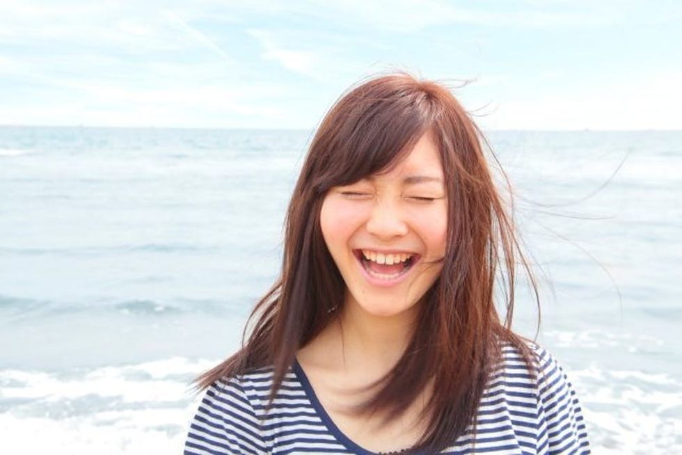 woman-beach-laughing-header