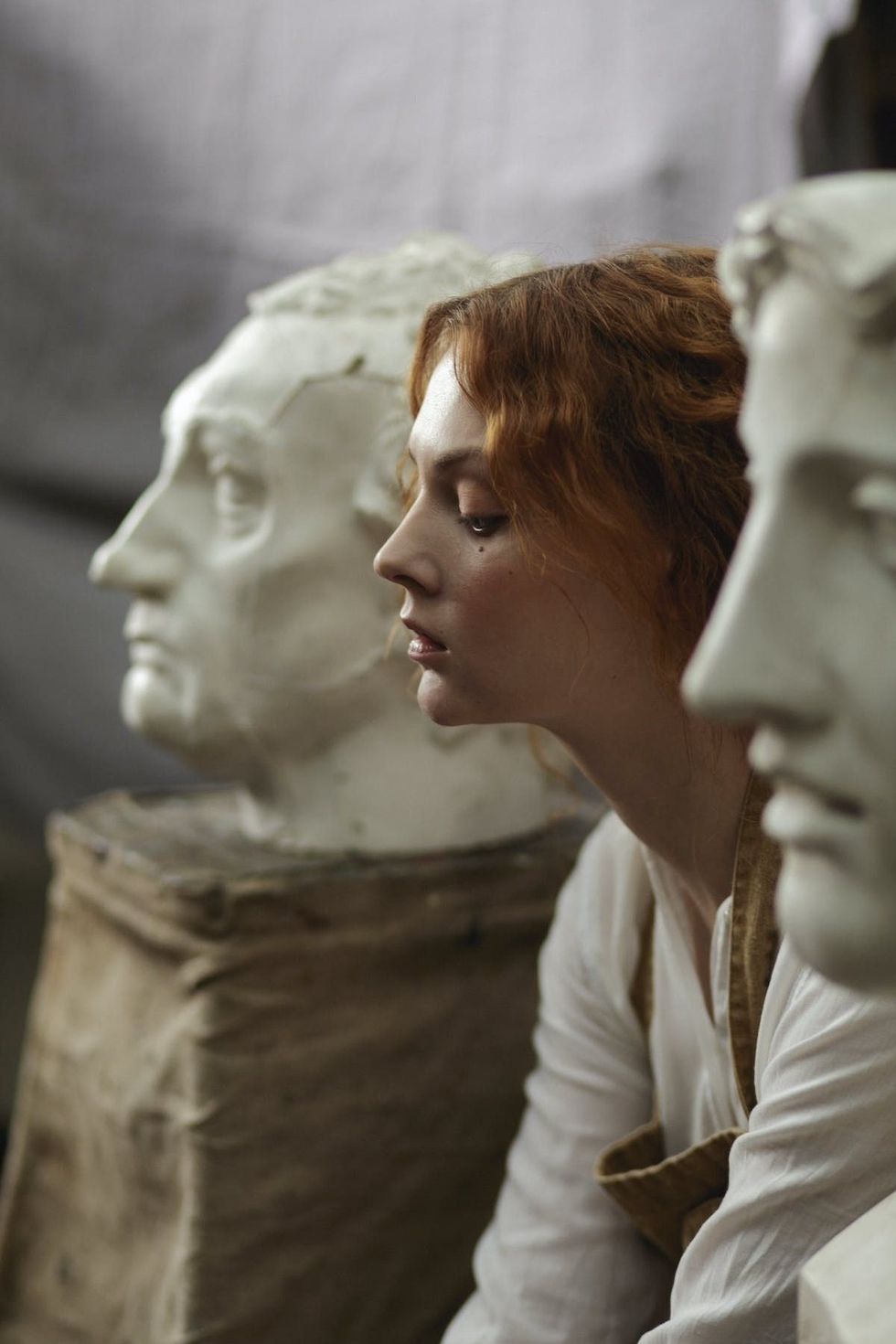 woman between two marble statues fourth wing tv show