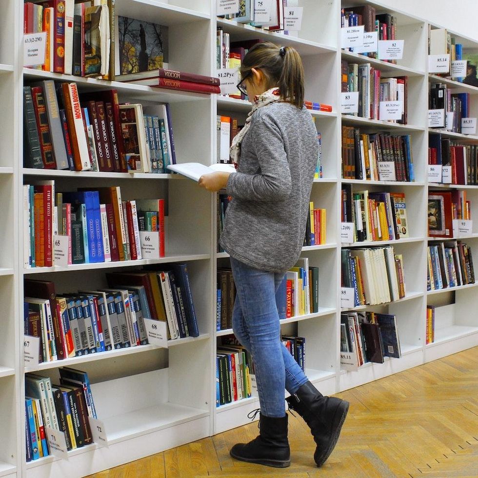 woman browsing the shelves at a bookstore