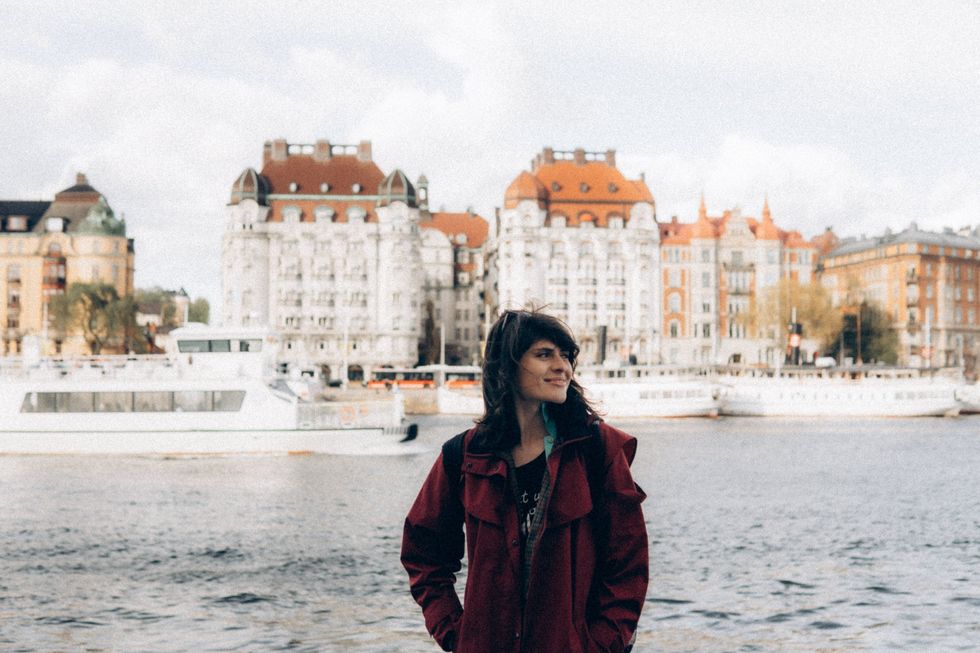 woman by the water in Stockholm, Sweden The Happiest Cities In The World
