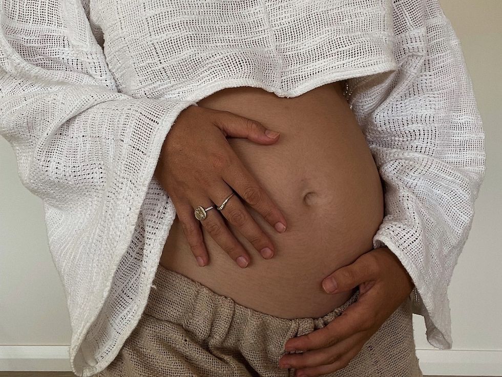 woman cradling her baby bump