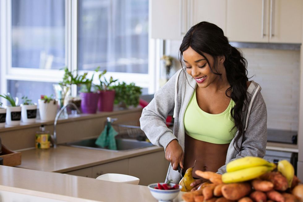 woman cutting fruit in her kitchen