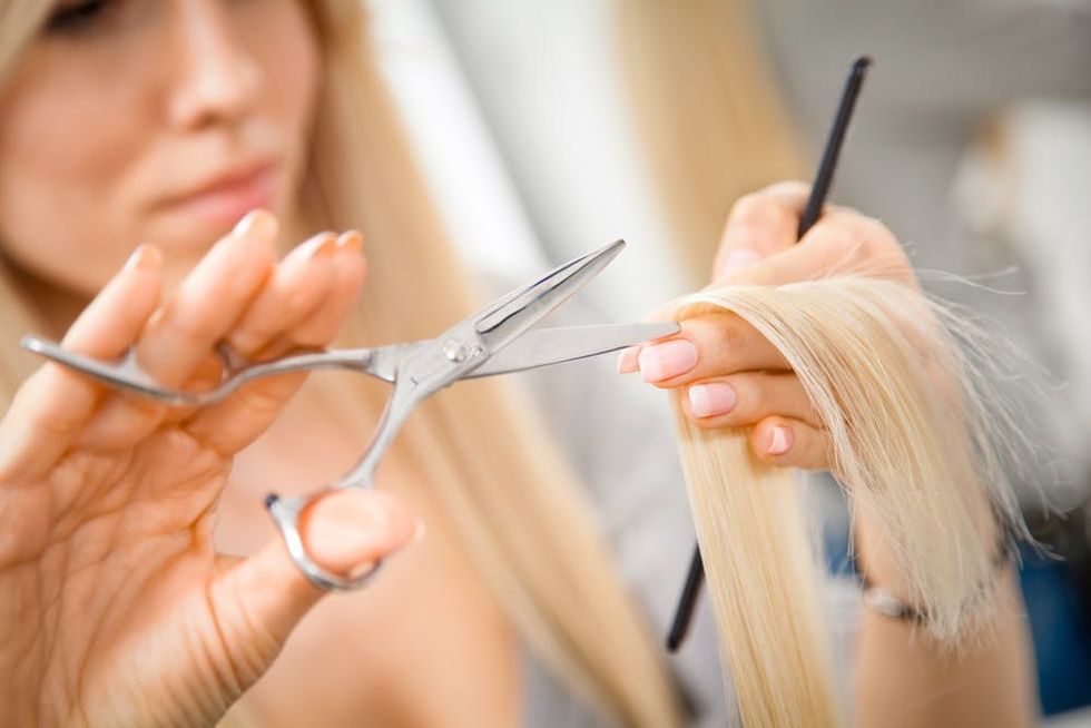 Woman cutting hair.
